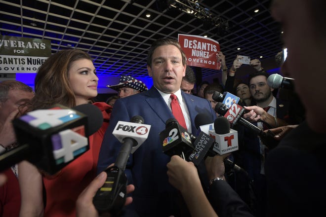 Florida Gov.-elect Ron DeSantis answers questions from reporters with his wife Casey, left, on Nov. 6 in Orlando. (AP Photo/Phelan M. Ebenhack)