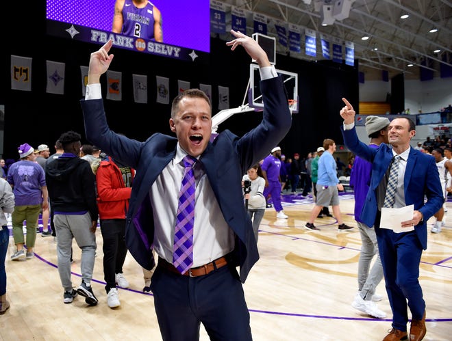 Furman head coach Bob Richey celebrates the Paladins' 12th win with the fans after Saturday's game against UNC-Wilmington.[RICHARD SHIRO/THE ASSOCIATED PRESS]