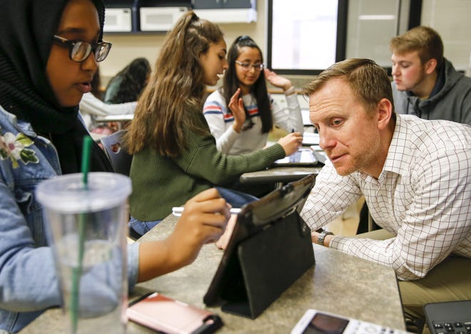 Precalculus and calculus teacher Brad Gmerek, right, helps senior Ifrah Ismail study for a calculus test in the Jag Room at Hilliard Bradley High School. Students can visit the Jag Room in their free time to receive help when they need it, and many visit during their lunch periods. [Tyler Schank/Dispatch]