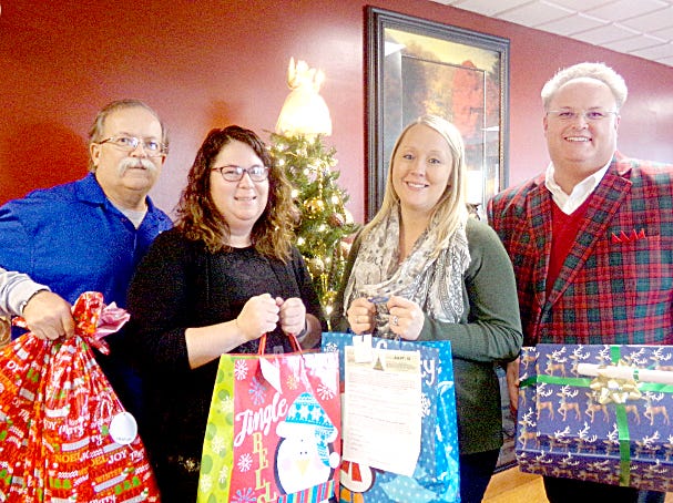 Ralph Ray, Cambridge Lions Club Member; Katie Jurkovich, social services coordinator; Kylee Quinn, wellness coordinator; and Shon Gress, executive director of Guernsey County Senior Citizens Center, Inc.-Meals on Wheels Guernsey County are pictured with “Share the Love” gifts collected for senior citizens donated by local Cambridge Lions Club, Federal Mogul/Champion, Colgate Palmolive, Hospice of Guernsey, Southeastern Ohio Physicians, Subway of Cambridge, and Guernsey County Commissioner’s Office.
