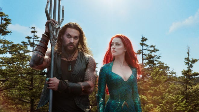 Aquaman (Jason Momoa) and Mera (Amber Heard) check out the surface world. [Warner Bros.]