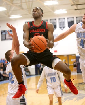 McKinley's Kobe Johnson flies through the lane on the way to the basket during the second quarter of their game at Louisville on Tuesday, Dec. 18, 2018. (CantonRep.com / Scott Heckel)