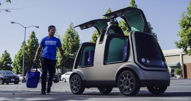 Nuro and grocery chain Kroger are teaming up to bring unmanned delivery service to customers. The companies said Tuesday, that Nuro's unmanned vehicle, the R1, will be added to a fleet of autonomous Prius vehicles that have run self-driving grocery delivery service in Scottsdale, Ariz., with vehicle operators since August. [Andrew Brown/AP Photo]
