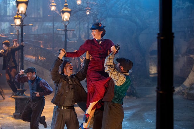 Mary (Emily Blunt) cavorts with London’s lamplighters. [Walt Disney Studios]