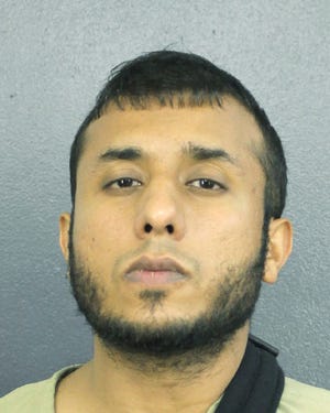 Tayyab Tahir Ismail under arrest in this Dec. 14 picture. An FBI affidavit unsealed Monday charges Ismail with posting detailed bomb-making instructions to online sites frequented by extremists such as supporters of the Islamic State group. [Broward County Sheriff's Office]