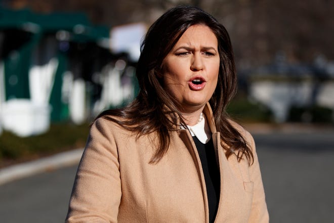 White House press secretary Sarah Huckabee Sanders talks with reporters outside the White House on Tuesday in Washington. [Evan Vucci/The Associated Press]