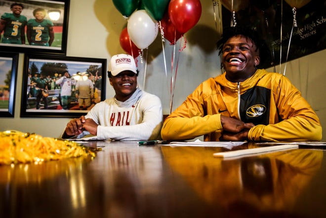 Nathaniel Peat, left, and Martez Manuel smile before signing during a signing day ceremony at the Cor building in Columbia on Wednesday, December 19, 2018. Peat signed a National Letter of Intent to play at Stanford, while Manuel signed a National Letter of Intent to play at Missouri. [Hunter Dyke/Tribune]
