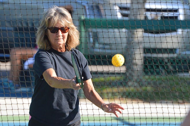 A woman serves the ball during a game of pickleball on the courts at Donnelly Park in downtown Mount Dora. [Whitney Lehnecker/Daily Commercial]