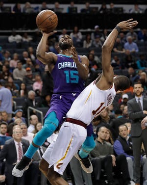 Charlotte Hornets' Kemba Walker (15) drives against Cleveland Cavaliers' Alec Burks (10) during the second half of an NBA basketball game in Charlotte, N.C., Wednesday, Dec. 19, 2018. (AP Photo/Chuck Burton)