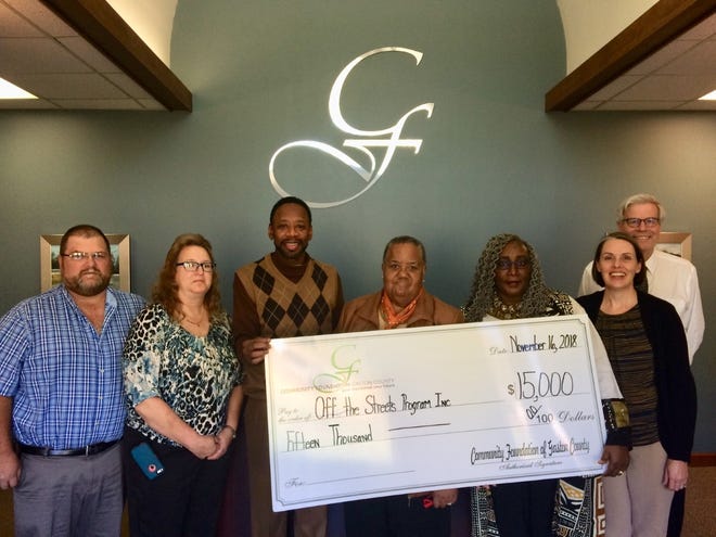 Representatives of Off the Street, Inc. and the Community Foundation celebrate the awarding of a $15,000 grant to support the program. [PROVIDED PHOTO]