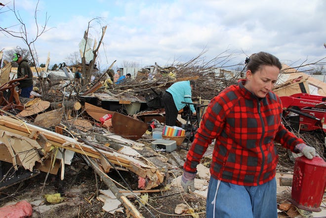 Amber Roberts of Vian moves items from the home of her mother, Karen Cook, on Dec. 1 in the Blackgum community. The house was destroyed following an EF-2 tornado Nov. 30 that hit western Sequoyah County. [MAX BRYAN/TIMES RECORD]