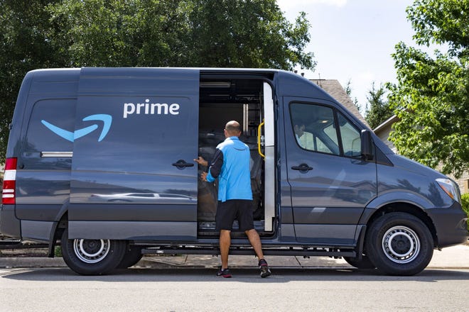 Delivery associate Carlos Villacorte delivers a package from an Amazon-branded delivery van in Cedar Park in this Aug. 16 file photo. [LYNDA M. GONZALEZ / AMERICAN-STATESMAN]