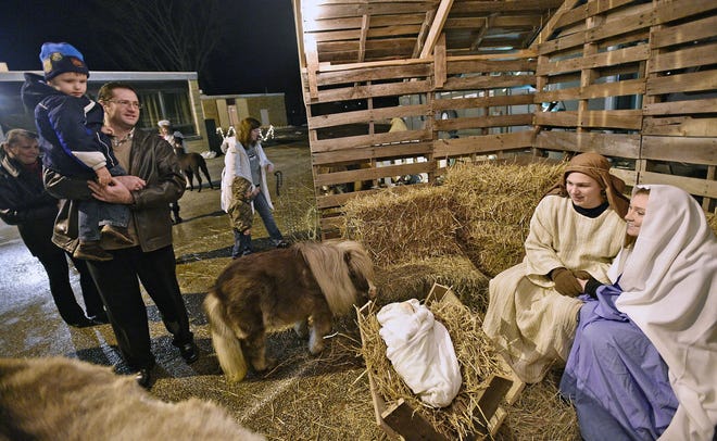 Slavik Olshanskiy and his son Vlad, of Millcreek Township, view Mary and Joseph, portrayed by Jake Widger and Samantha Beaver, both of Fairview Township, in a live Nativity scene at Fairview United Methodist Church in 2017. [FILE PHOTO/ERIE TIMES-NEWS]