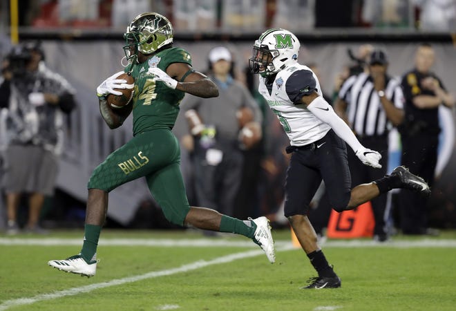 South Florida wide receiver Randall St. Felix (84) beats Marshall defensive back Chris Jackson (3) to the end zone on a 38-yard touchdown reception during Thursday night's Gasparilla Bowl game at Raymond James Stadium in Tampa. [THE ASSOCIATED PRESS / CHRIS O'MEARA]