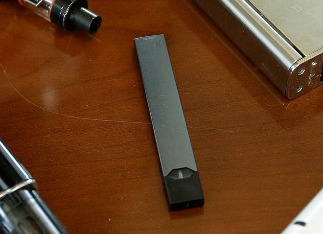 FILE - This April 10, 2018, file photo shows a Juul in Marshfield, Mass. Altria is spending $12.8 billion for a stake in e-vapor company JUUL as one of the world’s biggest tobacco companies tries to offset declining cigarette use. (AP Photo/Steven Senne, File)