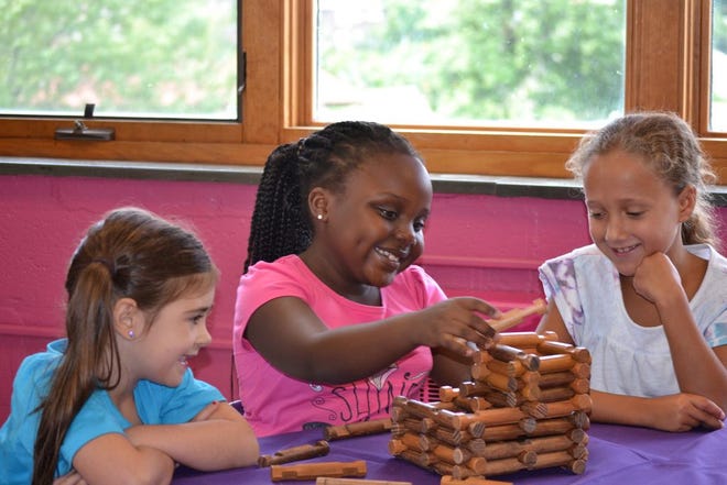 Lia Thomas-Flanders, Brittany Semakula, and Cyanna Paige constructing as part of the STEM program at Girls Inc. of Worcester.