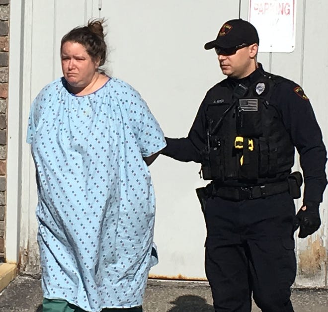 Windi C. Thomas, 44, left, is led out of the Erie police station following her arraignment on aggravated assault and other charges in the homicide of her 44-year-old boyfriend, Keeno Butler, at 1019 East Ave. on March 18. [TIM HAHN / ERIE TIMES-NEWS]