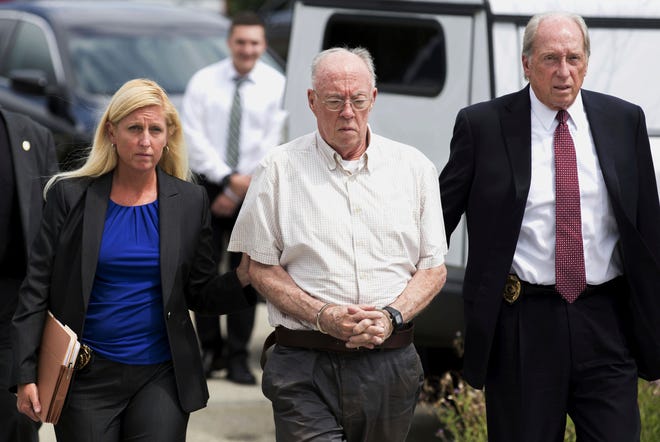 Rev. John Thomas Sweeney, center, walks into court to be arraigned in Leechburg, Pa., in 2017. The Roman Catholic priest on Friday became the first person sentenced to prison as a result of a Pennsylvania grand jury investigation that found hundreds of clergy had abused children over seven decades. [Antonella Crescimbeni/Pittsburgh Post-Gazette via AP, File]