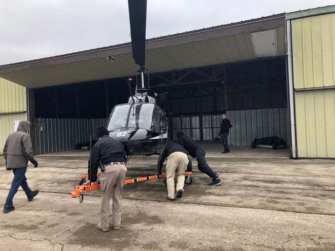 A former Air-One helicopter is moved into a new hangar at Albertus Airport on Friday, Dec. 21, 2018. Two helicopters will be flown away from Albertus, while three others will be temporarily moved to new hangars because a new agency is taking over the helicopters. [DERRICK MASON/THE JOURNAL-STANDARD STAFF]