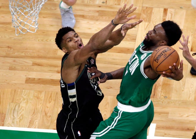 Celtics guard Jaylen Brown goes to the hoop against Bucks forward Giannis Antetokounmpo in the fourth quarter of Friday's game in Boston.