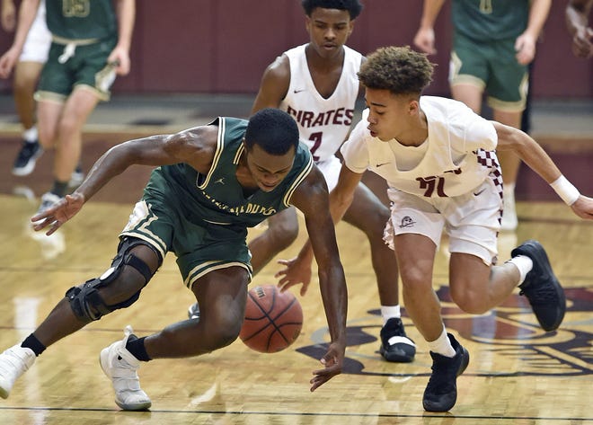 Saint Stephen's Jordan Edwards, left, tries to steal the ball from Braden River High's Karmani Gregory, right, who bats the ball back to his teammate Kamron Brooks (2) Friday night at Braden River High. [Herald-Tribune staff photo / Thomas Bender]