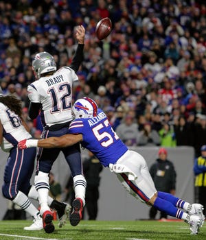 FILE - In this Oct. 29, 2018, file photo, New England Patriots quarterback Tom Brady (12) is hit from behind by Buffalo Bills linebacker Lorenzo Alexander (57) during an NFL football game in Orchard Park, N.Y. The Bills play at the patriots on Sunday. The Patriots can lock up a 10th consecutive division title this week with a win or tie against Buffalo. (AP Photo/Chris Cecere, File)