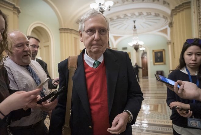 Senate Majority Leader Mitch McConnell, R-Ky., is met by reporters as he arrives at the Capitol Saturday morning on the first day of a partial government shutdown. Democratic lawmakers and some Republicans, are at odds with President Donald Trump on spending for his border wall. (AP Photo/J. Scott Applewhite)