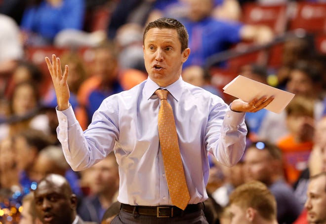 Florida head coach Mike White reacts in the first half of play against Florida Gulf Coast in the Orange Bowl Classic on Saturday in Sunrise. [Joe Skipper/The Associated Press]