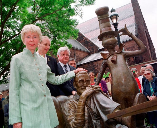 In this 2002 file photo, Audry Geisel, widow of Theodore Geisel, better known as children's book author Dr. Seuss, places her hand on the head of a just-unveiled sculpture of the writer next to his character, The Cat in the Hat, in Springfield, Mass.