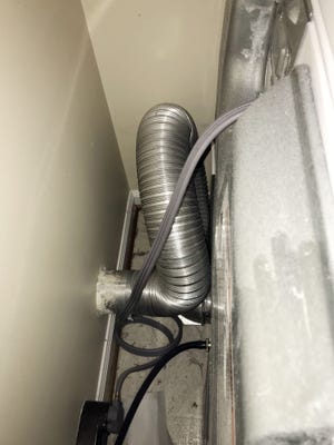 Relocating the dryer vent hood and exit pipe to a higher position on the wall can avoid this vent-pipe mess. [Tim Carter/Tribune Content Agency]