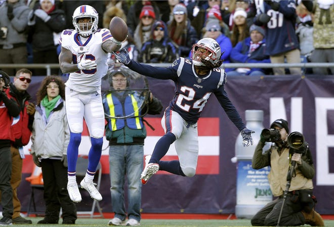 New England Patriots defensive back Stephon Gilmore, front, breaks up a pass in the end zone intended for Buffalo Bills wide receiver Robert Foster, rear, during the first half of an NFL football game Sunday in Foxborough, Mass. [STEVEN SENNE/ASSOCIATED PRESS]