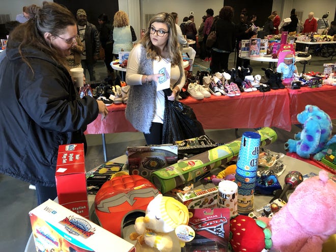 Destiny Church member Kelsey Perry, right, helps Charlotte Johns of Shelby to pick out toys for her three grandsons, ages, 8, 5 and 2, during a Hope for the Holidays event on Sunday. [Michael Barrett/The Gaston Gazette]