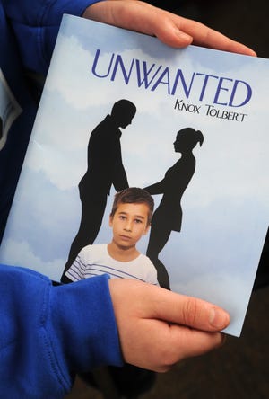 Donel Wheeler, 13, of East Stroudsburg, holds a copy of his book, 'Unwanted,' written under the pen name of Knox Tolbert on Wednesday, December 19, 2018. [KEITH R. STEVENSON/POCONO RECORD]