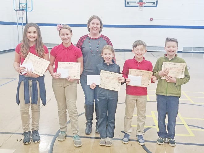 Pictured above is St. Charles Principal Brenda Mescher (center) with winners Charlotte Stough, Madison Moore, Kennedy Austin, Aiden Adams, and Andrew Richards. Not pictured is winner Kenzi Maynard.