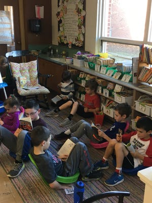 Second grade students in Mrs. Tobin's class at Wampatuck Elementary School in Scituate "Read for People in Need" to benefit Lend a Hand. (Aimee Greene)