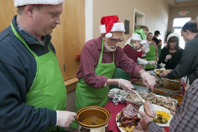 Serving up a Christmas meal at St. Mary's Church in Uxbridge, Craig Hay, left, and Jim Paquette. [Daily News and Wicked Local Staff Photo/Art Illman]