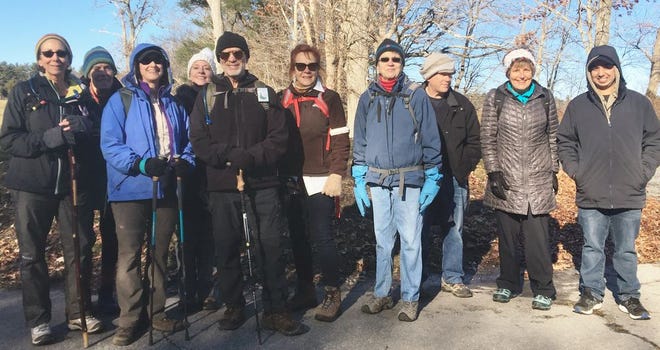 Beth Mosias, far left, of Weymouth led her 16th Christmas Day hike for the Appalachian Mountain Club around Ponkapoag Pond in the Blue Hills in Canton on Dec. 25 2018..