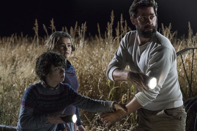 This image released by Paramount Pictures shows Noah Jupe, from left, Millicent Simmonds and John Krasinski in a scene from "A Quiet Place." With just a $17 million budget, John KrasinskiþÄôs horror hit grossed $340.7 million worldwide. It was the biggest original hit of a year typically dominated by sequels, superheroes and reboots. Of course, þÄúA Quiet PlaceþÄù will get its own sequel, slated for release in 2020. (Jonny Cournoyer/Paramount Pictures via AP)