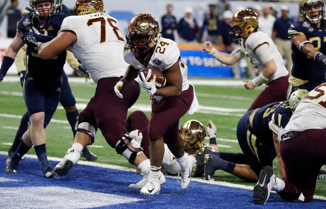 Minnesota running back Mohamed Ibrahim (24) scores a 1-yard touchdown against Georgia Tech during the second half of the Quick Lane Bowl NCAA college football game Wednesday, Dec. 26, 2018, in Detroit. (AP Photo/Carlos Osorio)
