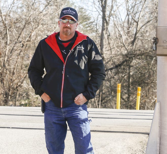 Tommy Trantham stands at the East Seventh Avenue railroad crossing on Wednesday where he recently helped get a woman out of her car before a train struck the vehicle. [Michael Coppley for The Dispatch]