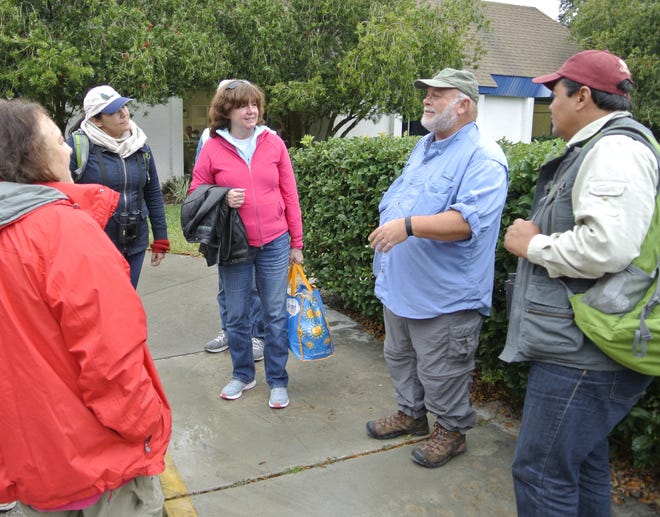 Internationally known birder Greg Miller, in light blue shirt, talks with a group of birders after their trip at a previous Birds of a Feather Fest. Miller returns for this year's event set for Feb. 7-10. [News-Tribune file]