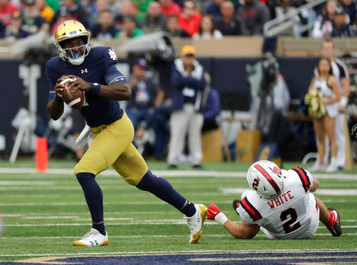 File- This Sept. 8, 2018, file photo shows Notre Dame quarterback Brandon Wimbush looking to pass against Ball State during the first half of an NCAA college football game in South Bend, Ind. Wimbush is practicing with Notre Dame to be the No. 2 quarterback for the third-ranked Fighting Irish in the Cotton Bowl amid questions about his future with the team after the College Football Playoff. There have been several media reports indicating that Wimbush has notified Notre Dame that he intends to transfer. (AP Photo/Nam Y. Huh, File)