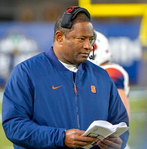 FILE - In this Nov. 17, 2018 file photo, Syracuse head coach Dino Babers watches during an NCAA college football game against Notre Dame at Yankee Stadium in New York. Babers has transformed Syracuse into a winner in three years at the helm. The Orange, who have won nine games and are ranked No. 17, meet No. 15 West Virginia on Friday, Dec. 28, 2018 in the Camping World Bowl. Babers, who just inked a contract extension, feels this is the start of sustained success that could lead to greater heights. (AP Photo/Howard Simmons, File)