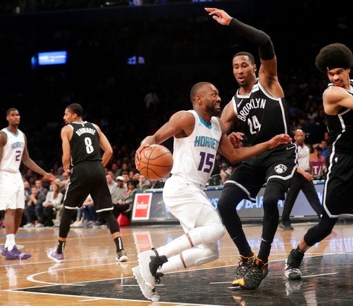 Charlotte Hornets' Kemba Walker (15) drives past Brooklyn Nets' Rondae Hollis-Jefferson (24) during the first half of an NBA basketball game Wednesday, Dec. 26, 2018, in New York. (AP Photo/Frank Franklin II)