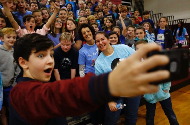 Bryce Gheisar, who played Julian in "Wonder," takes a selfie with fifth grade students at Hanover Middle School as part of the Wonder Fair. Greg Derr/The Patriot Ledger.