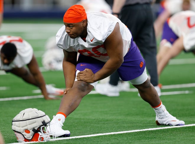 Clemson defensive tackle Dexter Lawrence stretches during team practice at AT&T Stadium in Arlington, Texas on Monday. Clemson is scheduled to play Notre Dame in the NCAA Cotton Bowl semi-final playoff Saturday. [FILE/THE ASSOCIATED PRESS]