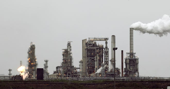 A refinery owned by Andeavor, formerly Tesoro Corp. including a gas flare flame that is part of normal plant operations, in Anacortes, Washington. [AP Photo/Ted S. Warren, File]