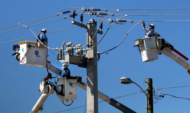 In this file photo from September 2016, Florida Power & Light workers gang up on a power pole at the intersection of U.S. 1 and Dunlawton Avenue in Port Orange following Hurricane Matthew. FPL has asked state regulators to reject a petition that seeks to force the utility to refund as much as $736 million to customers and reduce base electric rates. [News-Journal file]