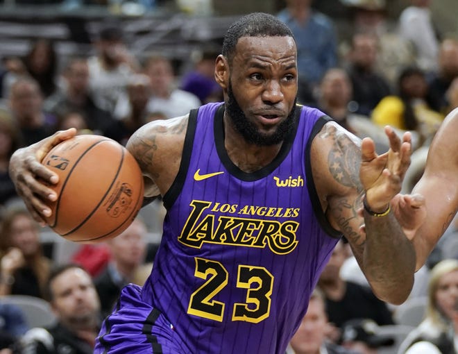 Los Angeles Lakers' LeBron James (23) drives against the San Antonio Spurs during a game on Dec. 7 in San Antonio. James was named The Associated Press Male Athlete of the Year on Thursday. [AP Photo/Darren Abate, File]