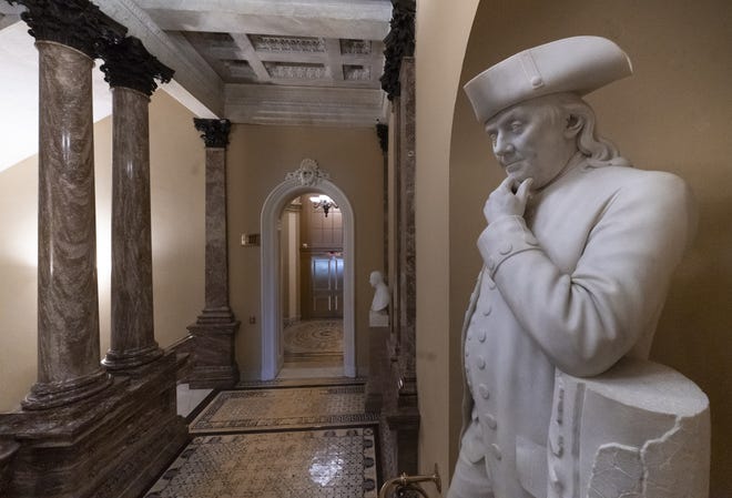 A statue of Benjamin Franklin is seen in an empty corridor outside the Senate at the Capitol in Washington, during a partial government shutdown. Chances look slim for ending the partial government shutdown any time soon. Lawmakers are away from Washington for the holidays and have been told they will get 24 hours' notice before having to return for a vote. [J. Scott Applewhite/AP Photo]